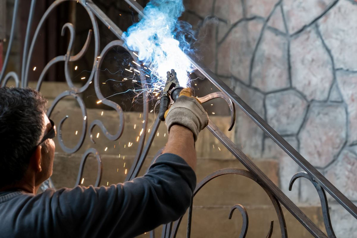 Welding a wrought iron stair railing for a residential project